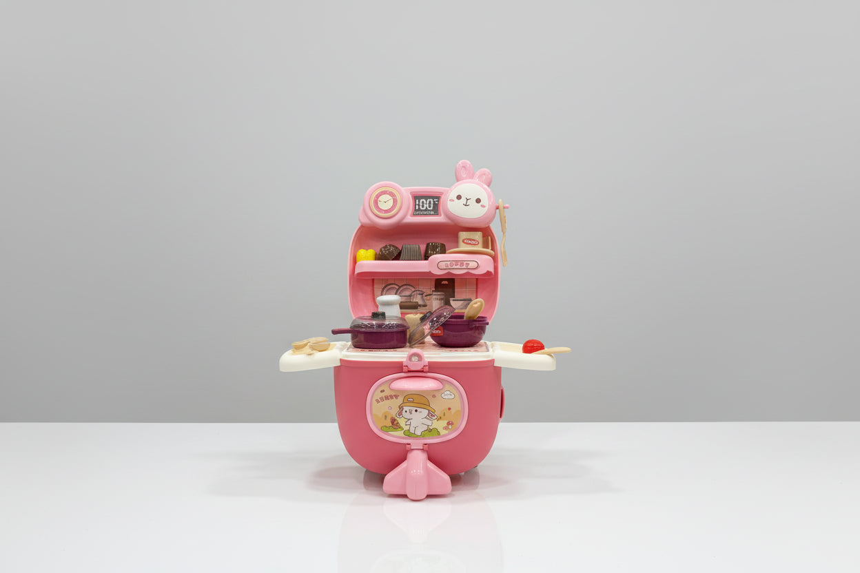 Pink toy kitchen set with cartoon character on a white surface