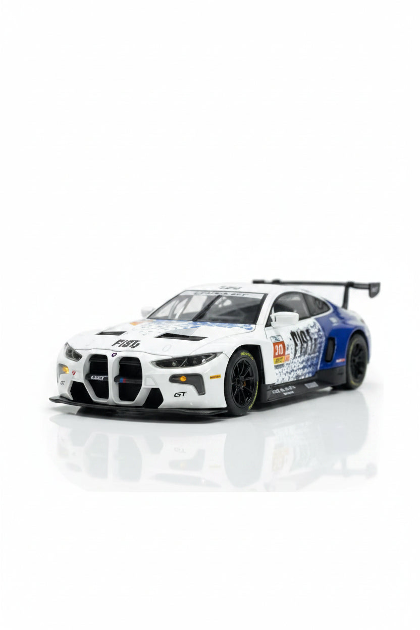 A scale model of a white and blue BMW M4 GT3 race car with sponsor decals, displayed on a reflective white surface with a blurred background of toys and plushers.